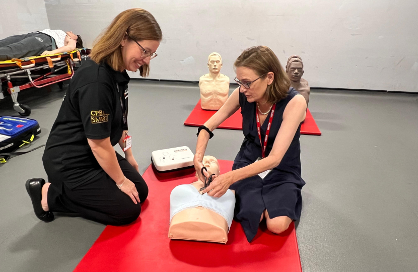 Rebecca attempting CPR on a female manikin 