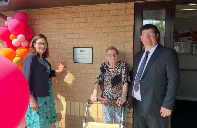 Dame Rebecca in front of plaque at Appleton House