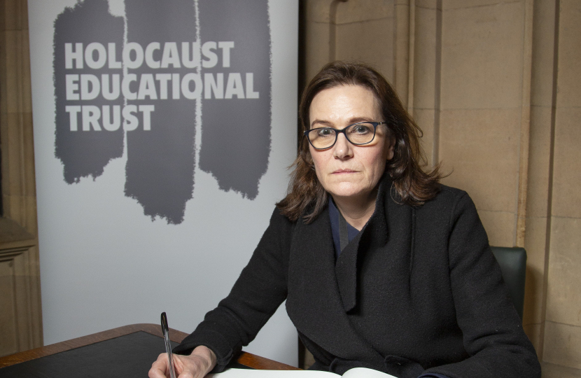 Rebecca signing the Book of Commitment