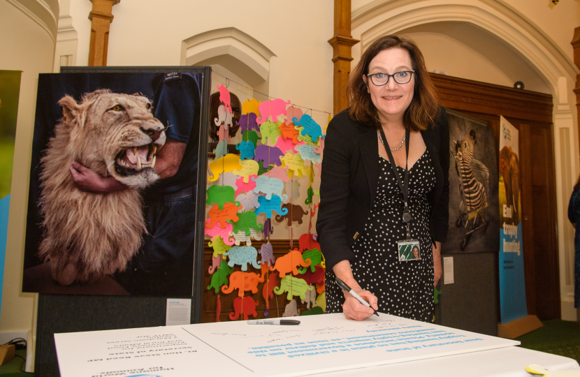 Rebecca signs giant postcard