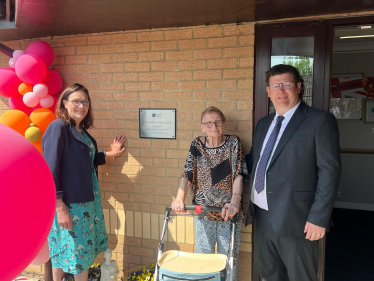 Dame Rebecca in front of plaque at Appleton House