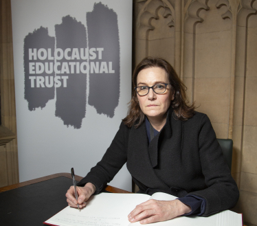 Rebecca signing the Book of Commitment