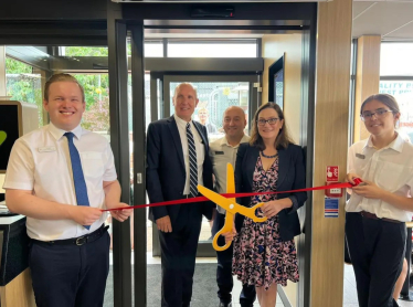 Rebecca cuts the ribbon