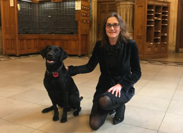Rebecca and a black lab in Parliament