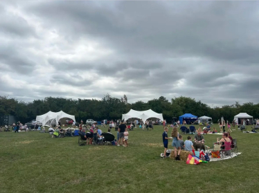 Stalls and people enjoying their picnics