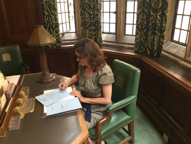 Rebecca signing documents